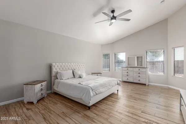 a living room with a bed furniture and a ceiling fan