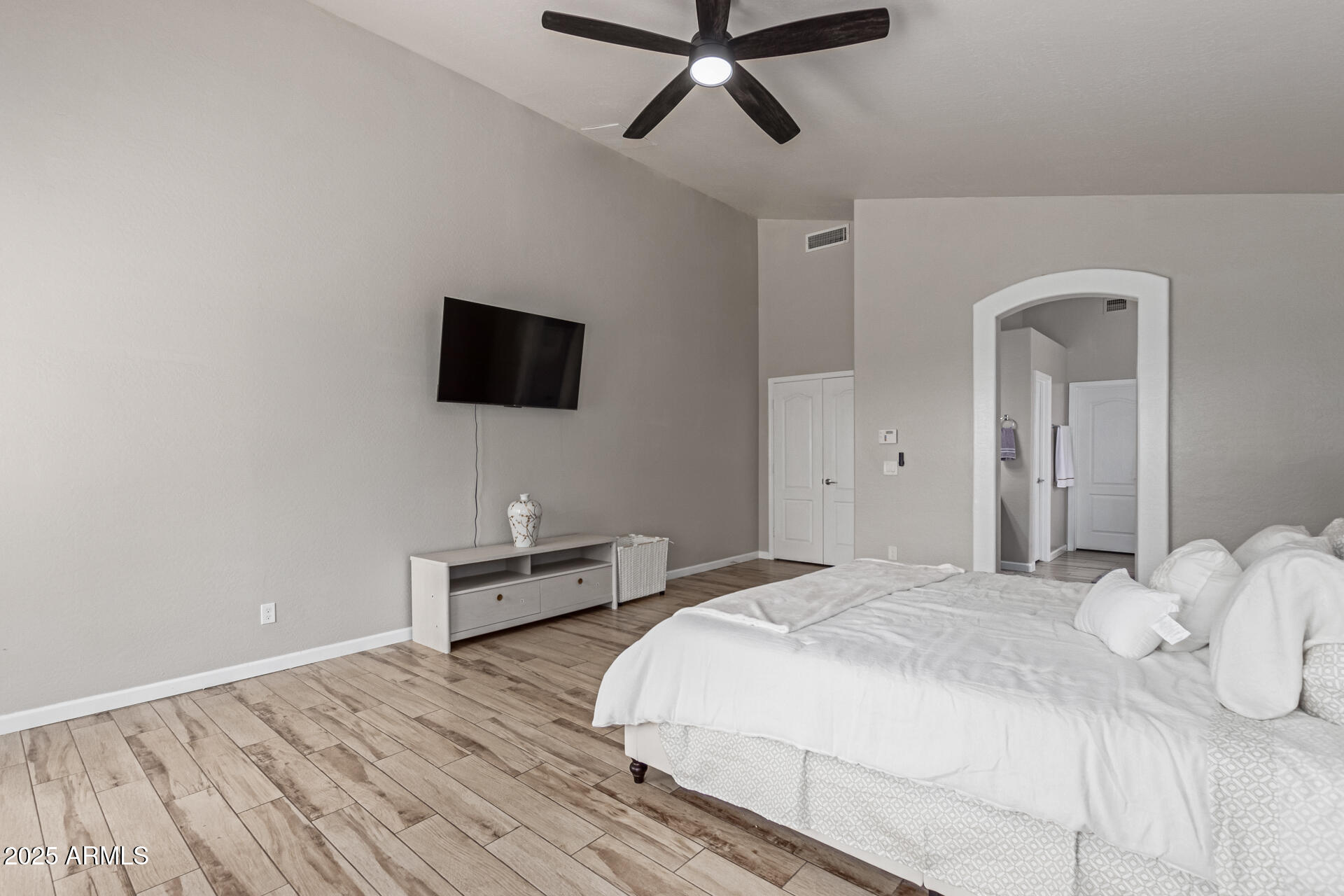 8632 South 10th Lane Phoenix, AZ 85041 - Photo 8 of 31 a bedroom with a bed and a flat screen tv