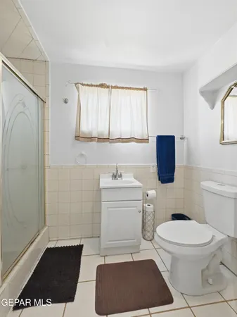 a bathroom with a toilet a sink and a window
