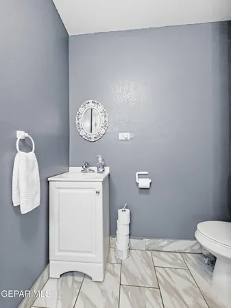 a bathroom with a sink mirror and vanity