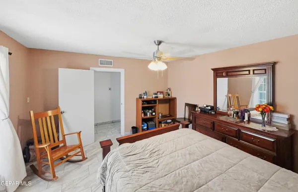 a bedroom with a bed a desk and chair