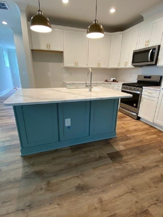 3925 Milltown Ridge Run Raleigh, NC 27612 - Photo 3 of 17 a kitchen with kitchen island granite countertop a sink a stove and cabinets