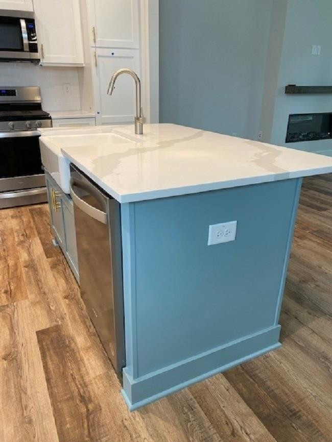 3925 Milltown Ridge Run Raleigh, NC 27612 - Photo 4 of 17 a kitchen with a sink a counter top space and cabinets