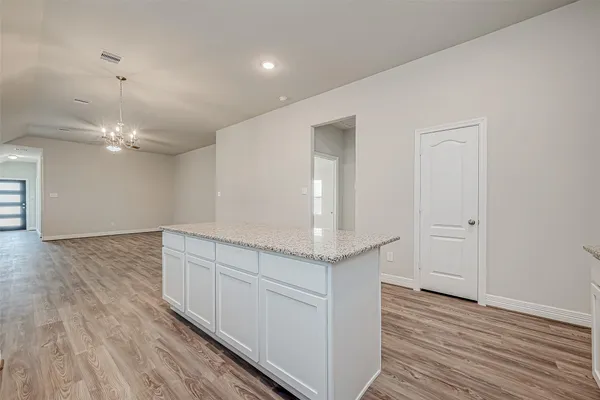 a view of a kitchen counter space and wooden floor