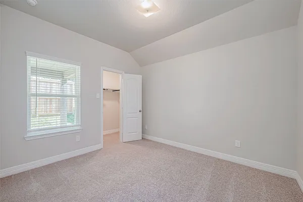 an empty room with windows and closet