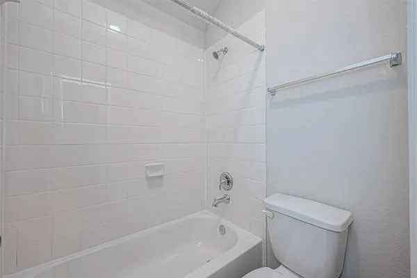 a white bath tub sitting next to a white toilet and sink