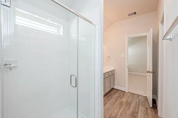 a bathroom with a sink and a glass door shower