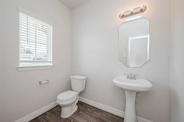 a bathroom with a sink toilet and a mirror