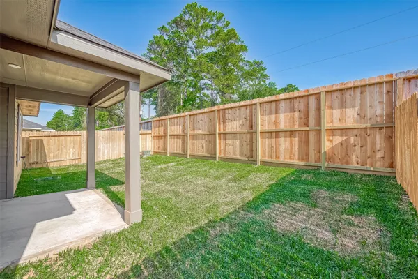 a view of a backyard with wooden fence