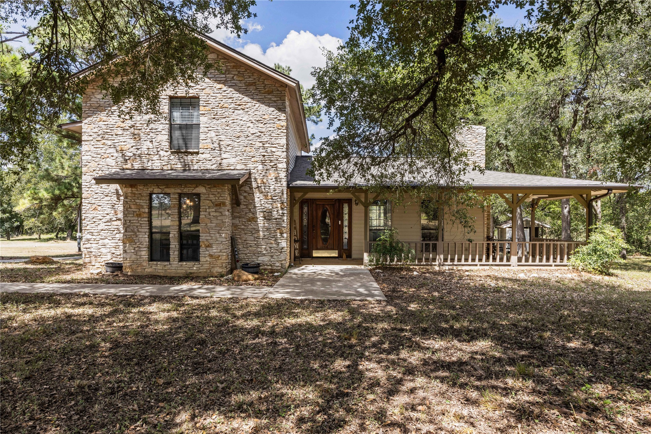 446 Roemer Road Elgin, TX 78621 - Photo 2 of 39 The home is full of charm - from the wrap around porch to the beautiful limestone exterior.