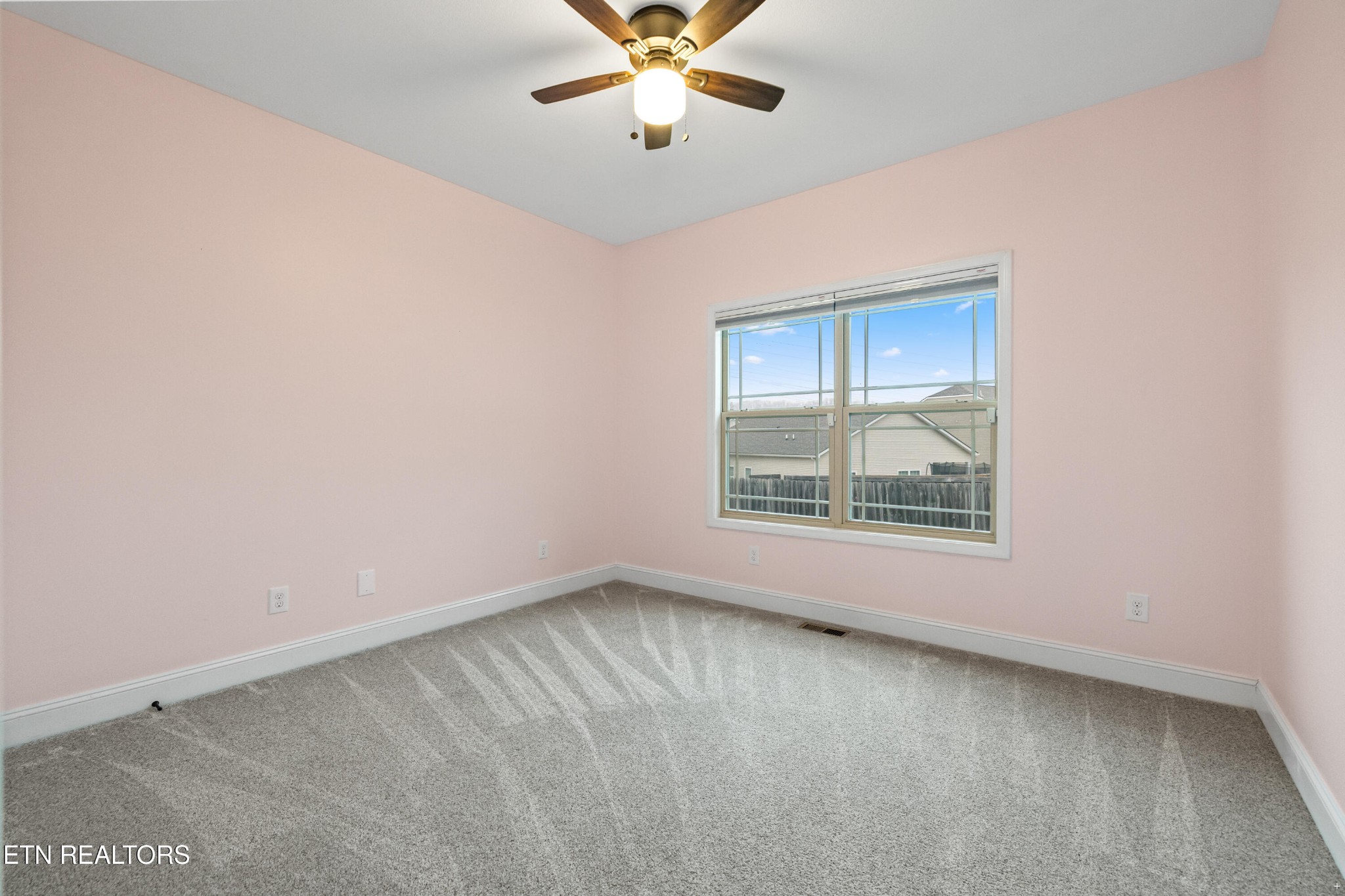 6101 Pembridge Road Knoxville, TN 37912 - Photo 19 of 29 an empty room with a window and a ceiling fan