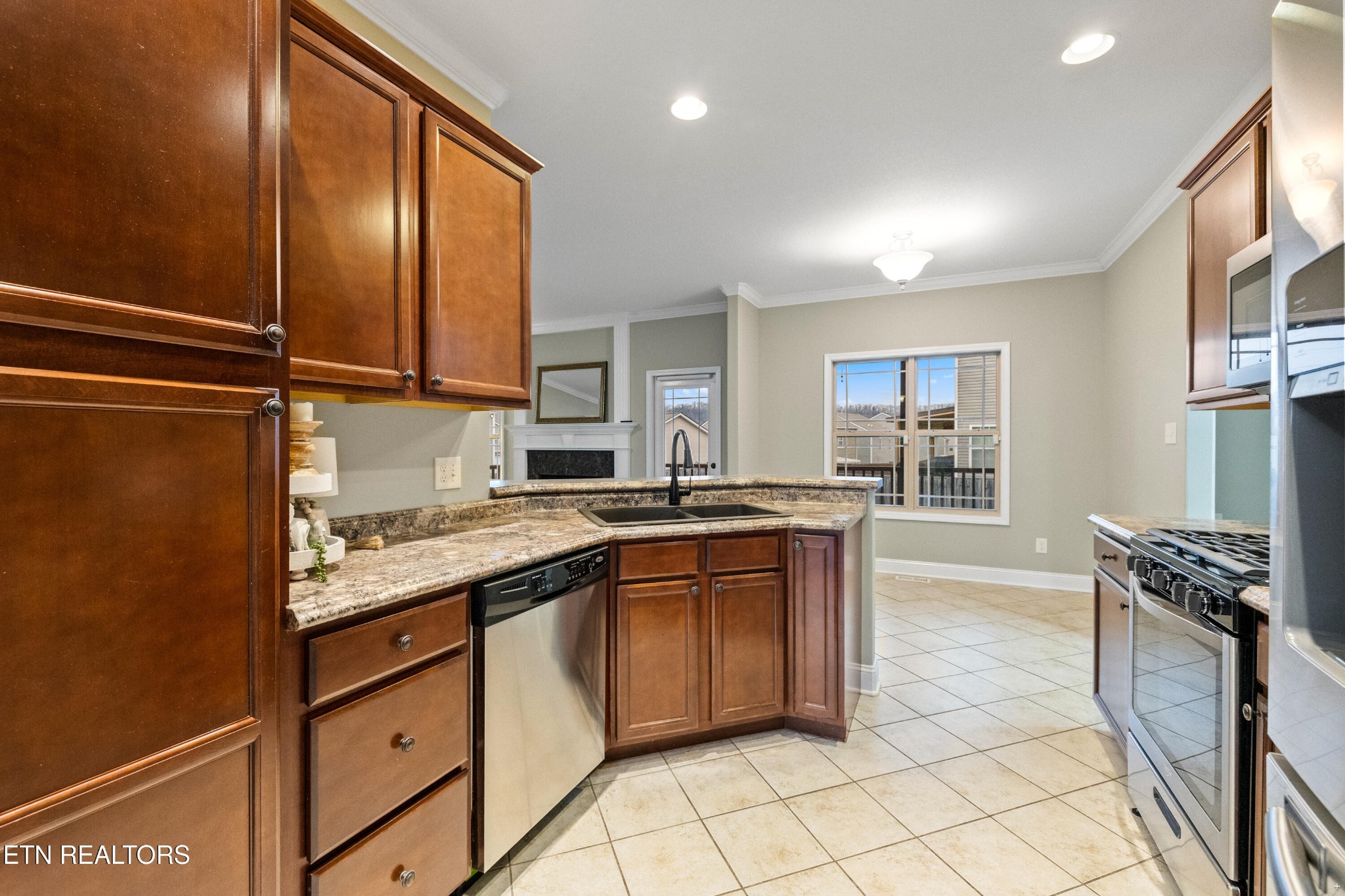 6101 Pembridge Road Knoxville, TN 37912 - Photo 9 of 29 a kitchen with granite countertop a sink stainless steel appliances and cabinets