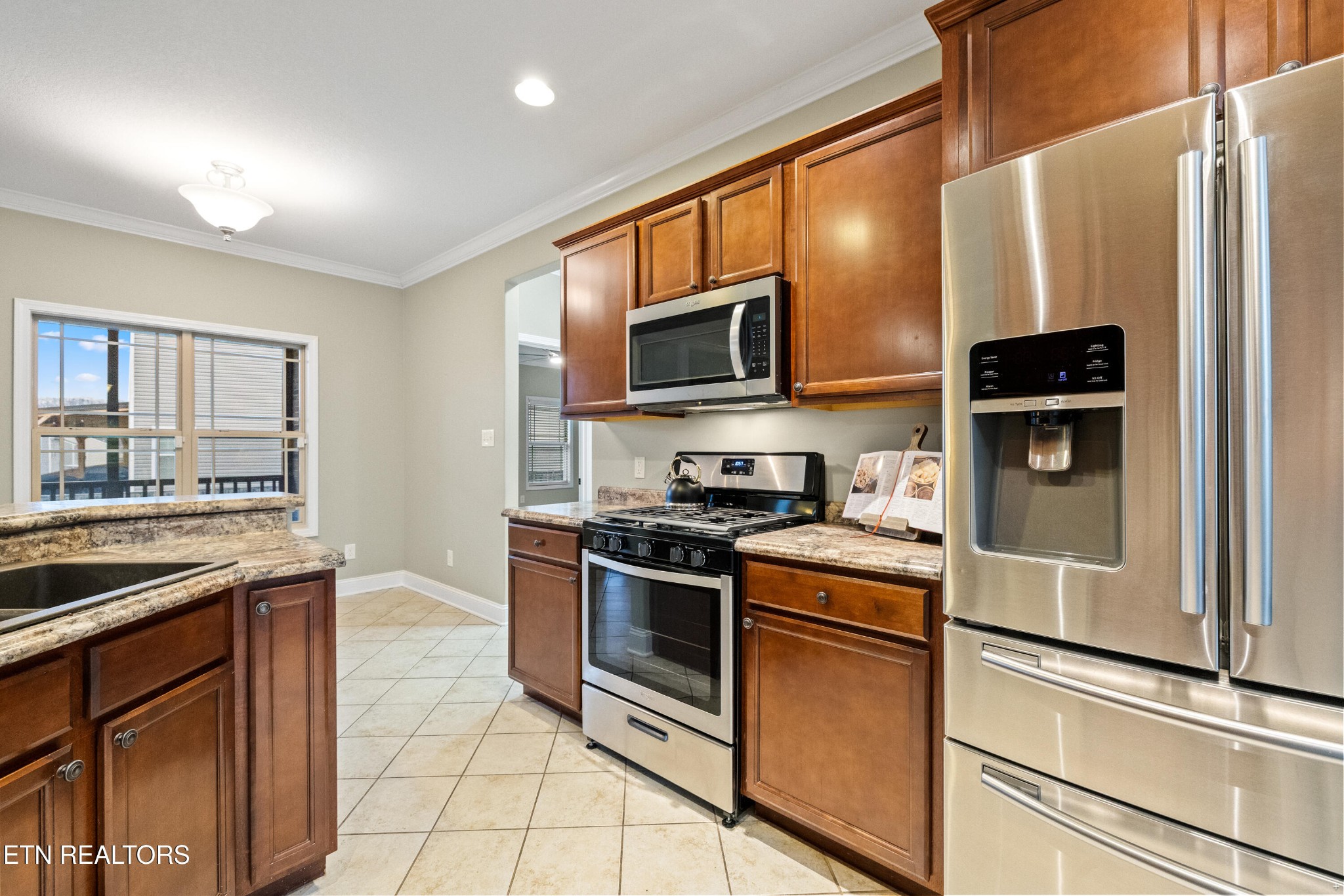 6101 Pembridge Road Knoxville, TN 37912 - Photo 10 of 29 a kitchen with stainless steel appliances granite countertop white cabinets a stove top oven a sink and dishwasher
