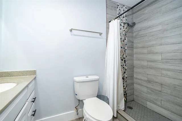 a bathroom with a toilet and shower