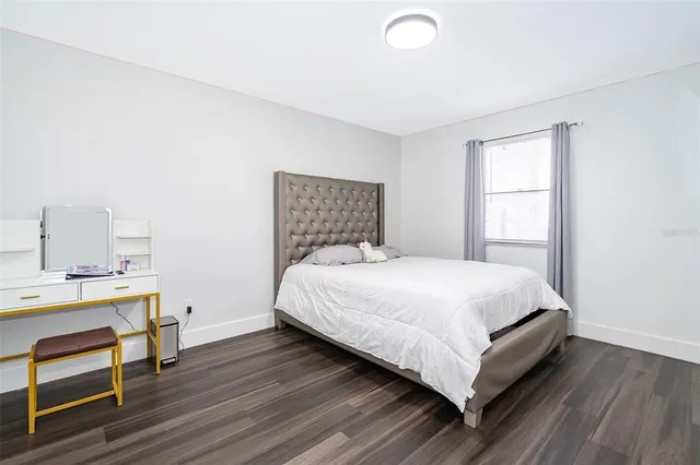 a bedroom with a bed and a desk