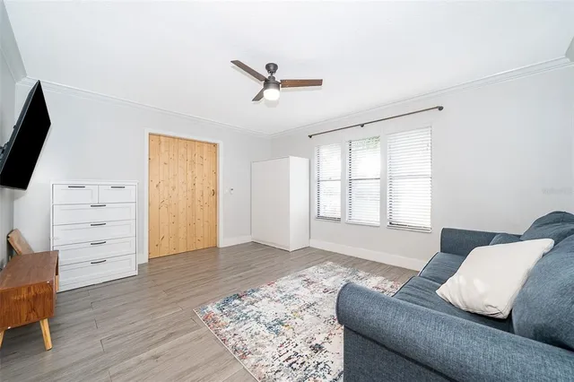a living room with furniture and wooden floor