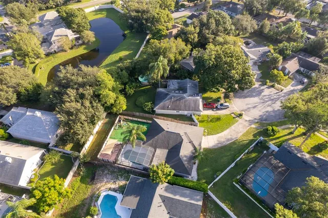 an aerial view of a house with a garden and swimming pool