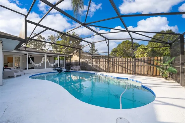 a view of a swimming pool with a patio and a tub
