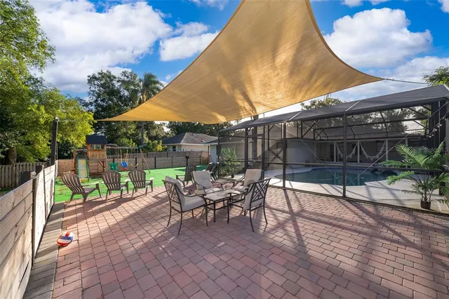 a view of a chairs and table in backyard