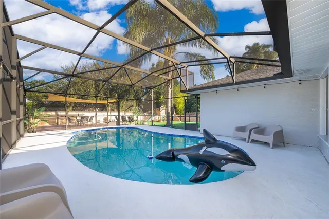 a view of a swimming pool with a lounge chair