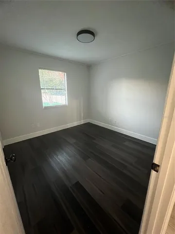 a view of an empty room and wooden floor