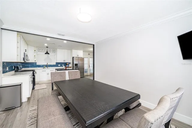 a living room with stainless steel appliances kitchen island furniture and a kitchen view