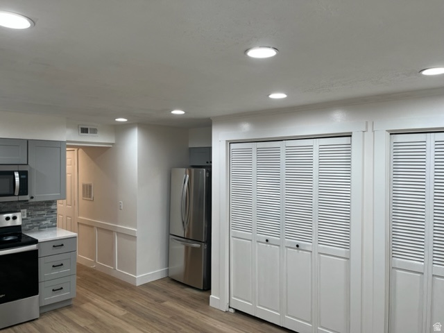 6884 670 East Midvale, UT 84047 - Photo 7 of 28 Kitchen featuring gray cabinets, stainless steel appliances, tasteful backsplash, light wood finished floors, and recessed lighting