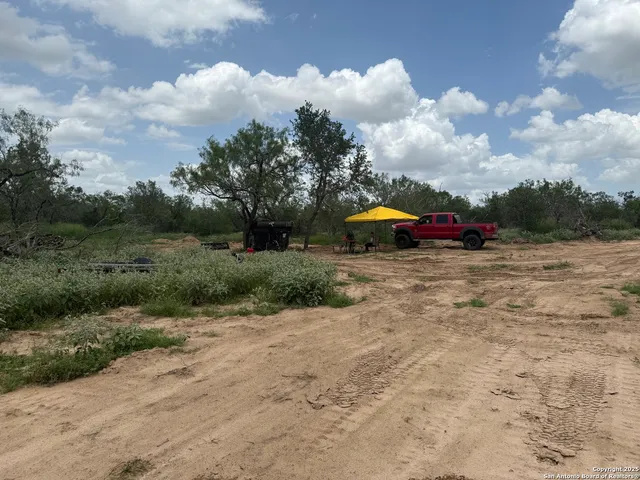 a view of yard with outdoor seating and barbeque oven