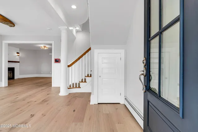 a view of an empty room with wooden floor