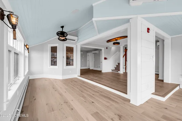 a view of empty room with wooden floor