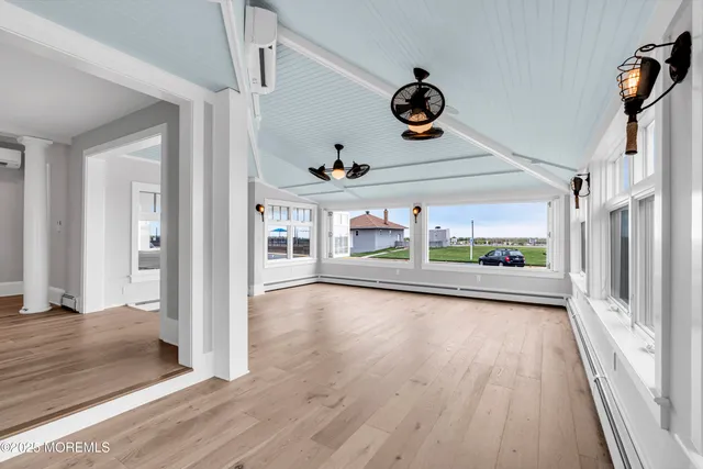a bedroom with a bed and painting on the wall