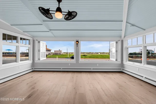 a spacious bedroom with a large bed and a wooden floor