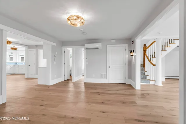 a view of a hallway with wooden floor and entryway