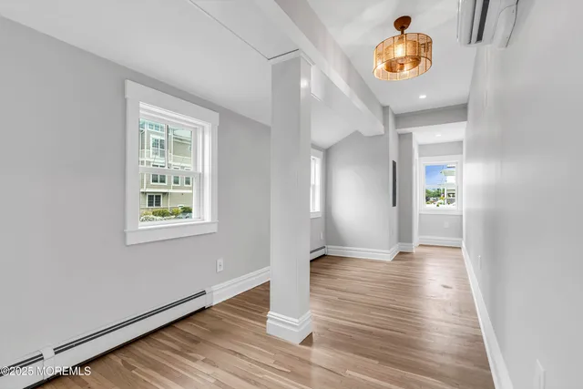 an empty room with cabinet and wooden floor