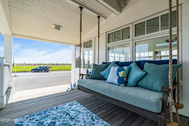 a view of an empty room with wooden floor fireplace and a window