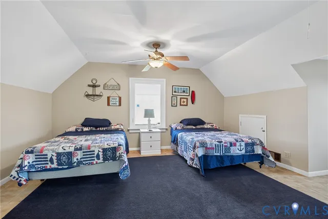 a bedroom with two beds and a chandelier