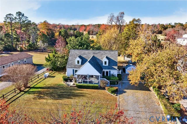 a view of house with tall trees
