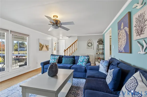 a living room with furniture and wooden floor