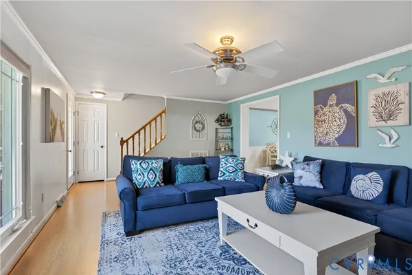 a living room with furniture and wooden floor