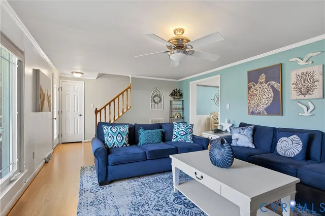 a living room with furniture and wooden floor