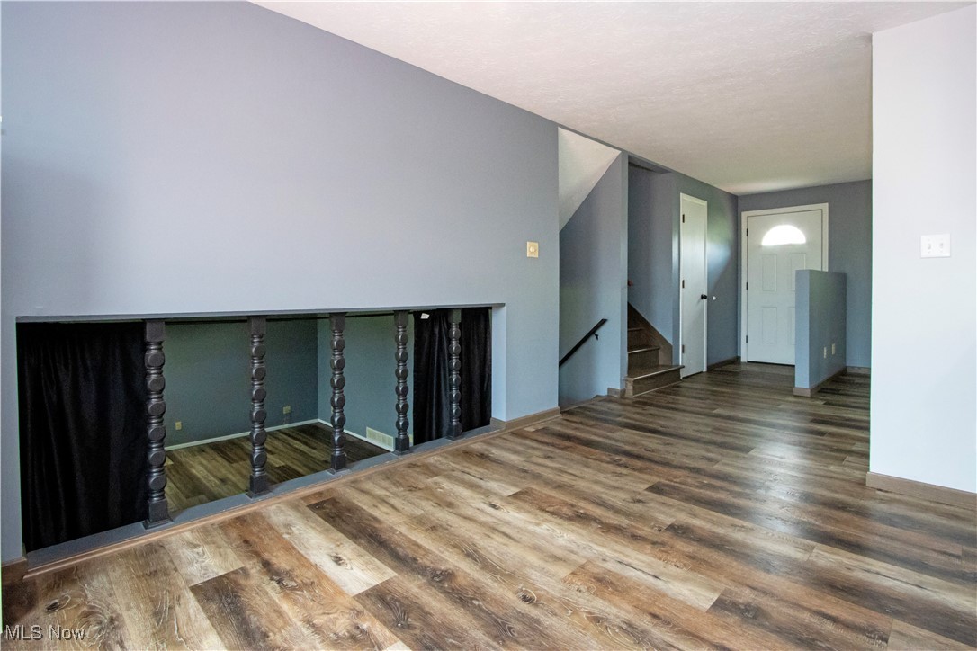 2276 Schellin Road Wooster, OH 44691 - Photo 13 of 48 Unfurnished living room with wood finished floors and stairway