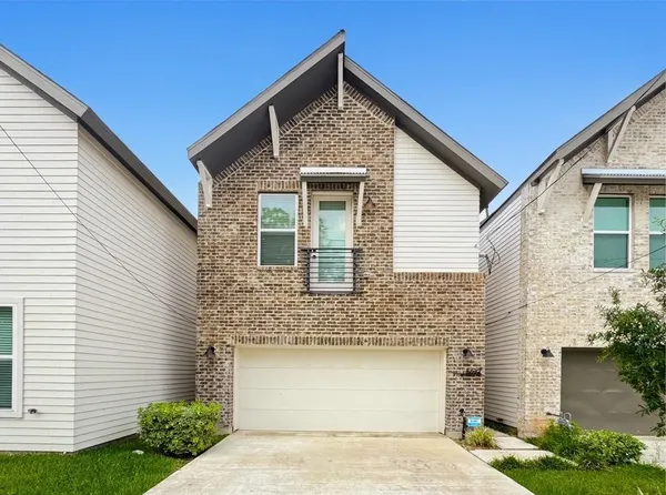 a front view of a house with garage