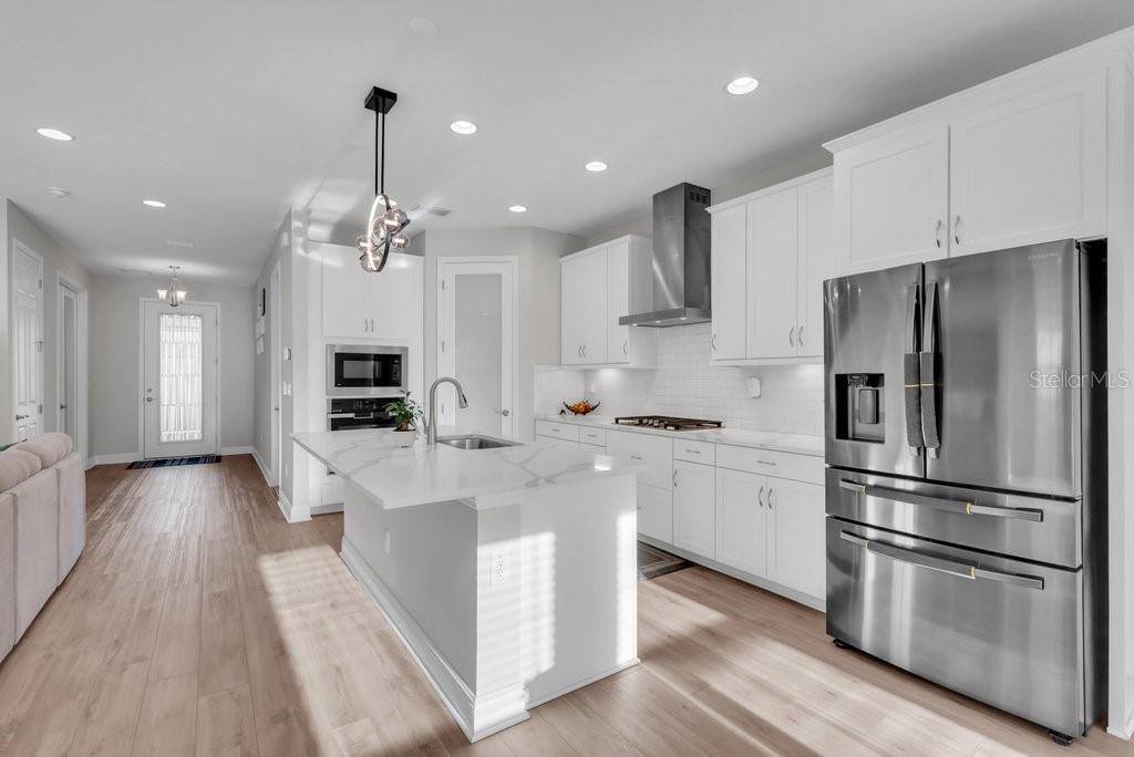 14604 Horse Trot Road Lithia, FL 33547 - Photo 14 of 62 a kitchen with stainless steel appliances a refrigerator stove microwave and cabinets