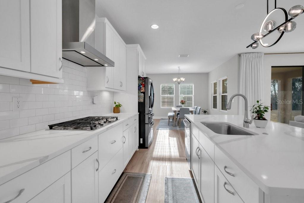 14604 Horse Trot Road Lithia, FL 33547 - Photo 17 of 62 a kitchen with stainless steel appliances granite countertop a sink stove and refrigerator