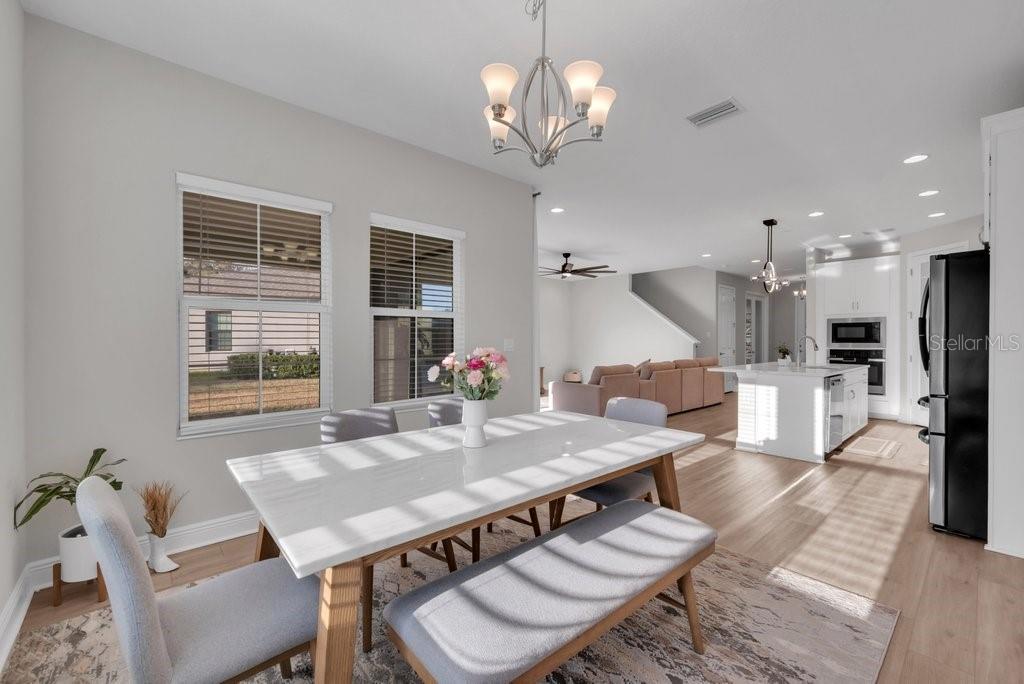 14604 Horse Trot Road Lithia, FL 33547 - Photo 19 of 62 a view of a dining room with furniture window and wooden floor