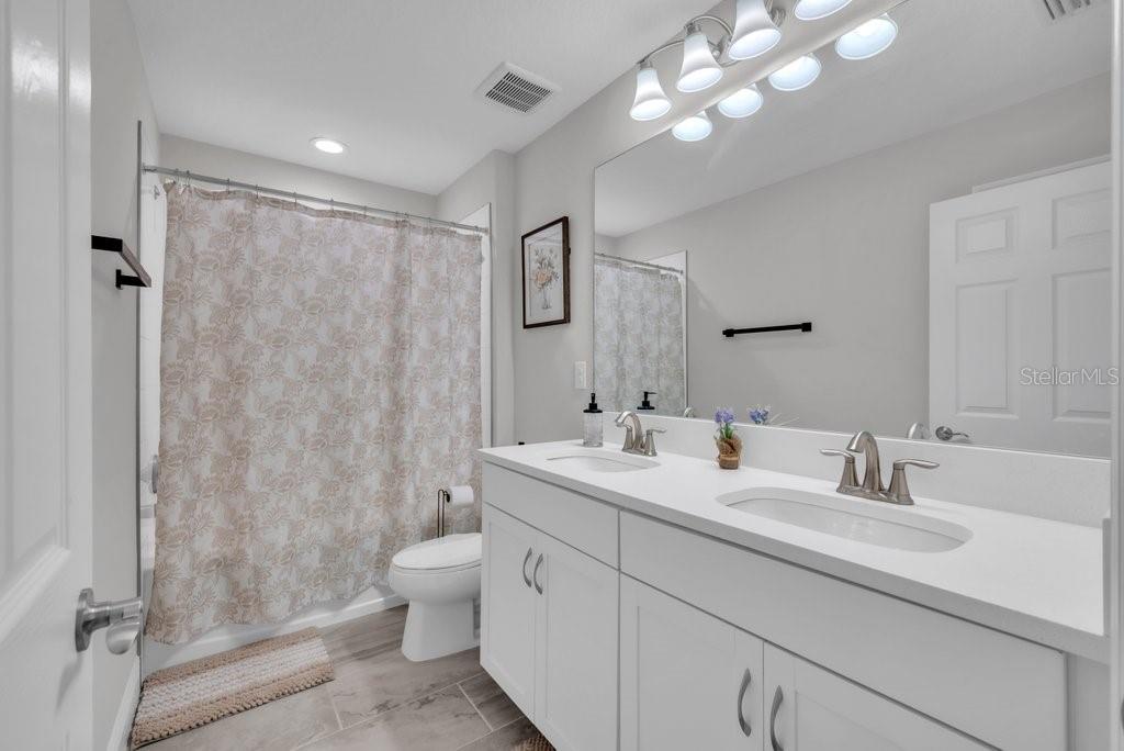 14604 Horse Trot Road Lithia, FL 33547 - Photo 33 of 62 a bathroom with a double vanity sink mirror and toilet