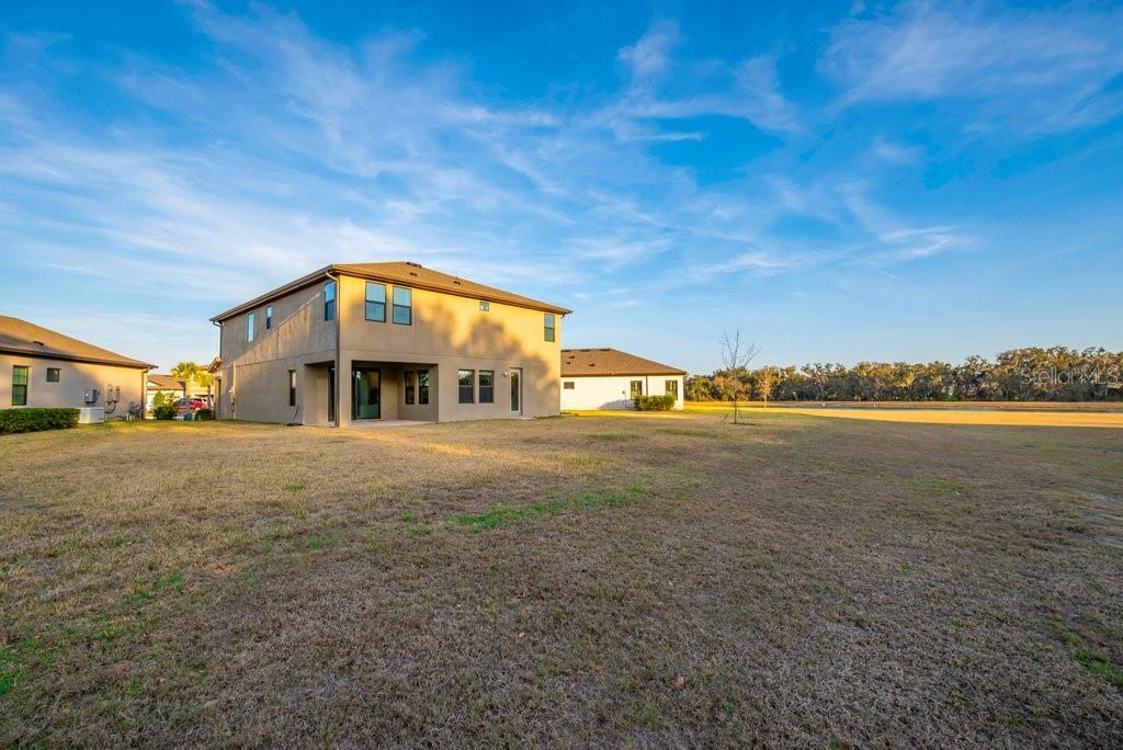 14604 Horse Trot Road Lithia, FL 33547 - Photo 37 of 62 a view of a big house with a big yard and large trees