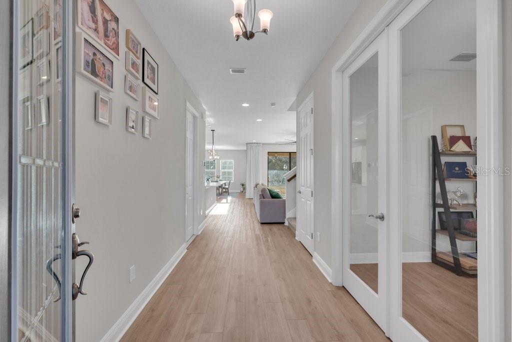14604 Horse Trot Road Lithia, FL 33547 - Photo 8 of 62 a view of a hallway with wooden floor and a living room