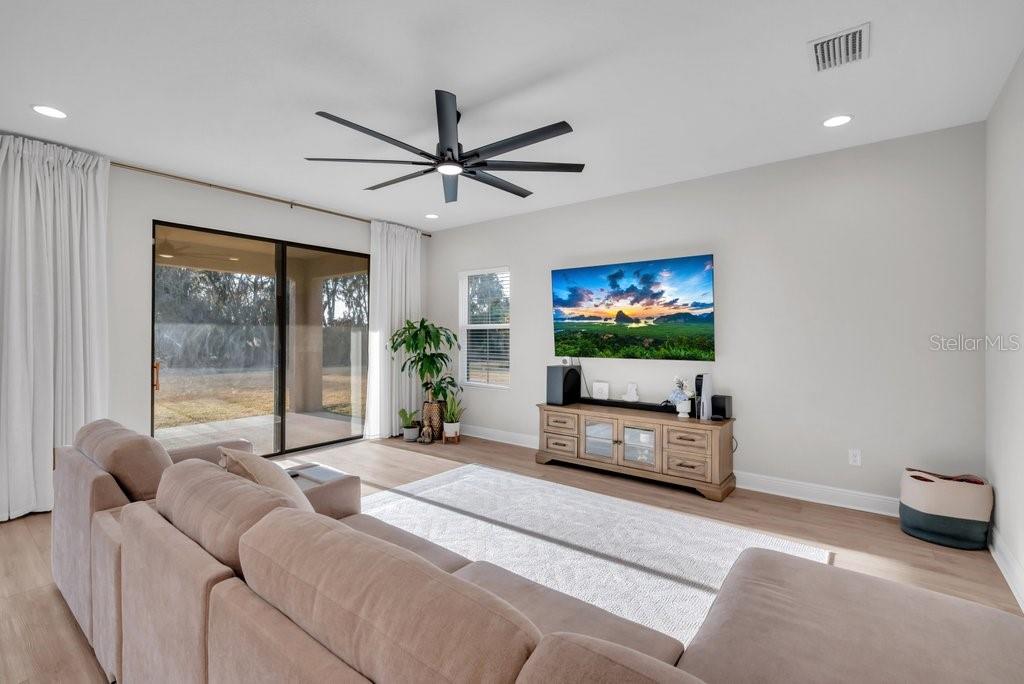 14604 Horse Trot Road Lithia, FL 33547 - Photo 9 of 62 a living room with furniture a flat screen tv and a large window