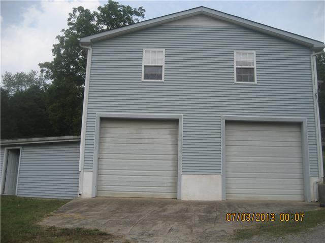 4716 Bull Run Road Ashland City, TN 37015 - Photo 1 of 10 Unfinished basement/garage has very high ceilings for future living expansion, shop, or family space. Stairs could easily be added for this expansion. Breezeway is connected to the garage/basement.